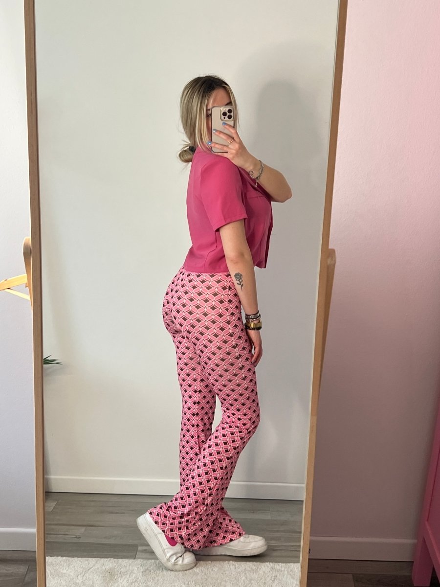 Pantaloni rosa a zampa con fantasia