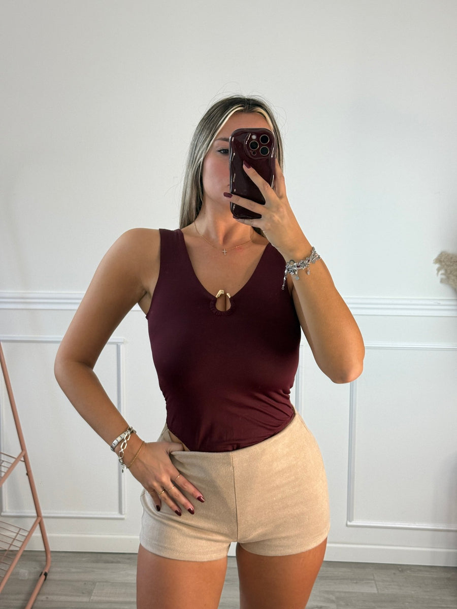 Body sgambato con scollo a goccia e charm metallico dorato
